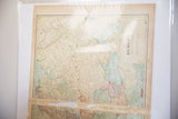 Angled view of the vintage Cram's 1907 Europe map, with light blue seas and prominent fold.