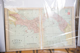 Two-page spread of Cram's 1907 Panama map, pale land and sea under plastic.