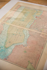 Aged paper and pale blue waterways on the 1907 Cram's New York City map.
