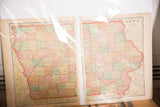 The two separate pages of the 1907 Cram's Map of Iowa, showing aged paper and pastel-colored counties.