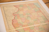 Angled close-up of a vintage 1907 Illinois map showing the western border and aged coloring.