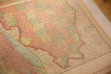 Angled view of the warm, aged paper and pastel counties on a 1907 map of Illinois.