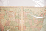 Aged paper and visible wear along the center seam of the 1907 United States map.
