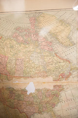 Antique 1907 map of North America showing aged paper, faded colors, and a missing section.