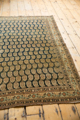 Finely woven antique Haji Jalili Tabriz rug corner with dark navy boteh, intricate rust borders, and selvage.