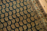 Finely woven boteh pattern and intricate border of an Antique Haji Jalili Tabriz rug.