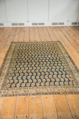 Finely woven Persian Haji Jalili Tabriz rug's lower border, dark navy boteh, and restored selvage.