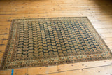 Antique Tabriz rug's restored side cord, showcasing fine boteh pattern in navy and ivory.