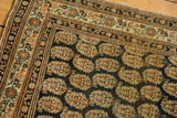 Finely woven antique Haji Jalili Tabriz rug corner, dark navy boteh field and intricate ivory, rust borders.