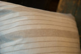 Textured vintage linen pillow fabric with muted gray and off-white stripes.