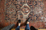 Time-worn vintage Karaja rug with navy ground, brick red border, and geometric medallions.