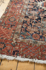 Circa 1920s Karaja rug with worn brick red geometric border, navy field, and fringe.