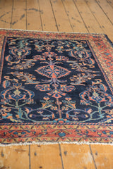 Vintage Lilihan rug detail: navy field, dusty raspberry floral vinery, light pile.