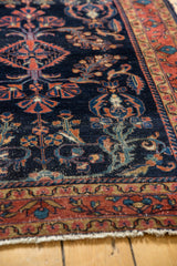Hand-knotted Persian Lilihan rug, navy field, serrated leaves, floral vinery, and brick red border.