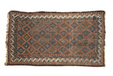 Antique Belouch rug with geometric multi-medallion pattern in indigo, terracotta, and brown.