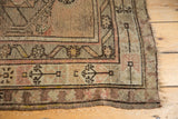 Corner detail of vintage Caucasian runner, geometric germinating trees, blush, and exposed foundation.