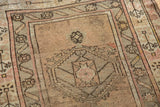 Faded blush and antique ivory geometric blossomed patterns on a vintage Caucasian runner.