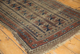 Tattered fringe and geometric camel, red, blue border of an antique Belouch runner.
