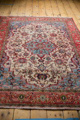 Red floral border and light tatter on the ivory-field distressed Meshed rug.