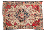 Antique Farahan Sarouk rug with an ivory field, cobalt blue medallion, and raspberry red floral details.