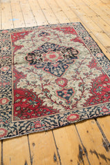 Intricate red and blue floral border and fringed edge of an Antique Farahan Sarouk rug.
