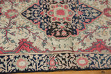 Hand-knotted raspberry, indigo, and ivory floral motifs on an antique Farahan Sarouk rug.