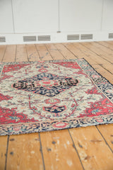 Raspberry red and indigo floral border and fringe of the antique Farahan Sarouk rug.