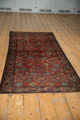 Vintage Hamadan runner's raspberry red field, Herati-like motifs, and Mir Serbend border.