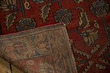 Hand-knotted foundation and secured edge of the Vintage Hamadan rug, revealing raspberry red motifs.