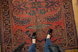 Exuberant bouquets of flowers and vinery on a cherry red hand-knotted Lilihan rug.