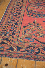 Cherry red floral field with deep indigo border on a vintage Lilihan rug.