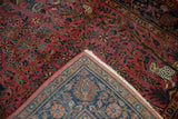 Antique Kashan rug with spotted leopard, raspberry field, indigo border, ivory fringe.