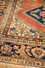 Vintage Hamadan runner close-up with terracotta, navy, and ivory Herati motifs.
