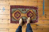 Playful aubergine, dusty gold, and sea foam green village weave on a distressed Oushak rug.