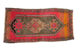 Distressed vintage Oushak rug mat featuring pink fuchsia, tangerine, charcoal geometric village weave, 1'6