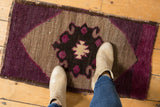 Distressed Oushak rug, playful aubergine, charcoal, and silver asymmetric motif.