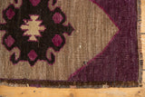 Distressed Oushak rug corner, purple aubergine and charcoal motif with secured end.