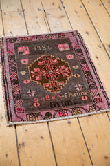 Distressed Oushak rug detail: 1982 date, bold fuchsia, charcoal, tangerine village weave.
