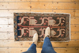 Playful village weave Oushak rug with asymmetric dark beige, terracotta, and blue motifs.