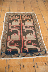 Vintage Oushak rug lower corner, playful dark beige village motifs, red outlines, blue band.