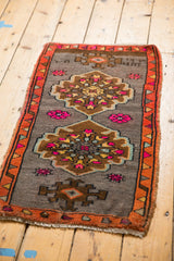 Distressed vintage Oushak rug with tangerine orange border and playful fuchsia village motifs.