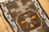 Hand-knotted Oushak rug corner showing playful village weave in charcoal, silver, and tangerine.