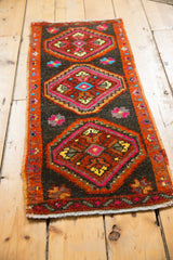 Narrow banded border and stepped medallions in cherry red, saffron, and sky blue.