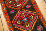 Detail of vintage Oushak rug: concentric stepped medallion, vibrant blue flowers, and orange border.