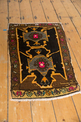 Vintage Oushak rug close-up: charcoal, oxidized silver, tangerine, and fuchsia asymmetric motif.