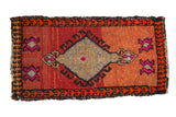 Distressed vintage Oushak rug mat with asymmetric blood orange and hot pink geometric village design.