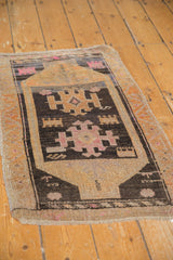 Distressed vintage Oushak rug mat with playful village weave and bright pink accents.