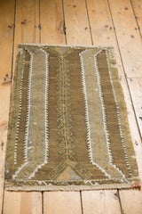 Distressed vintage hand woven Jijim rug in coffee brown and ivory with germinating plant motifs.