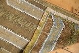Distressed shaggy texture and geometric plant motifs of a hand-woven vintage Jijim rug.