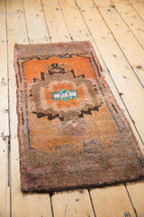 Distressed vintage Oushak rug, showing tangerine, brown, and blue asymmetric village weave.